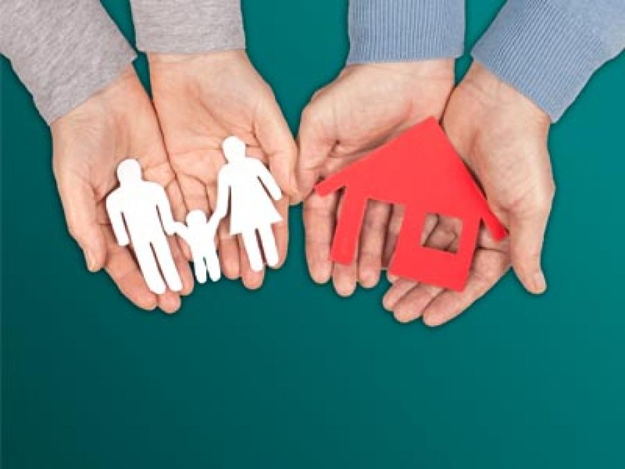 Family and home cutout in hands