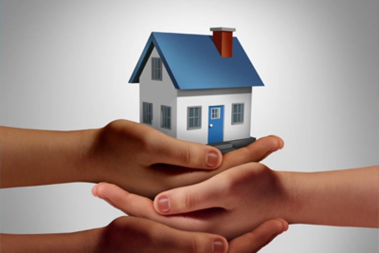Hands holding a house together